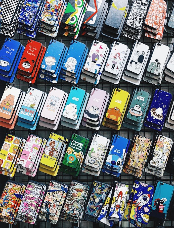 A colorful collection of various cartoon-themed phone cases arranged in rows, perfect for mobile accessory enthusiasts.